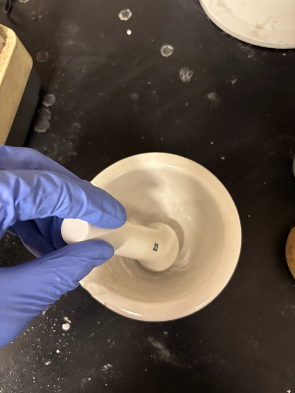 Mortar-and-pestle grinding of eggshell into bioactive filler.